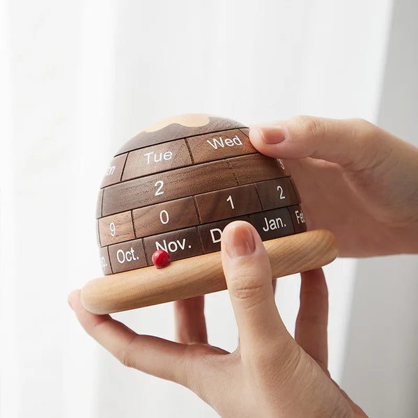 Walnut Planet Perpetual Desk Calendar on the hand