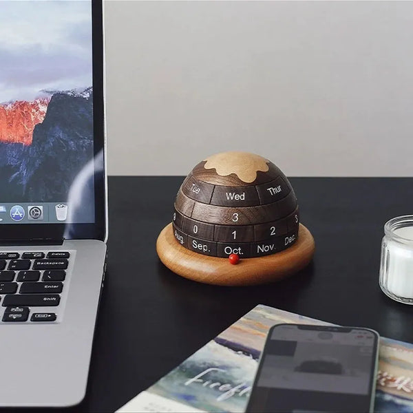 Walnut Planet Perpetual Desk Calendar on the desk